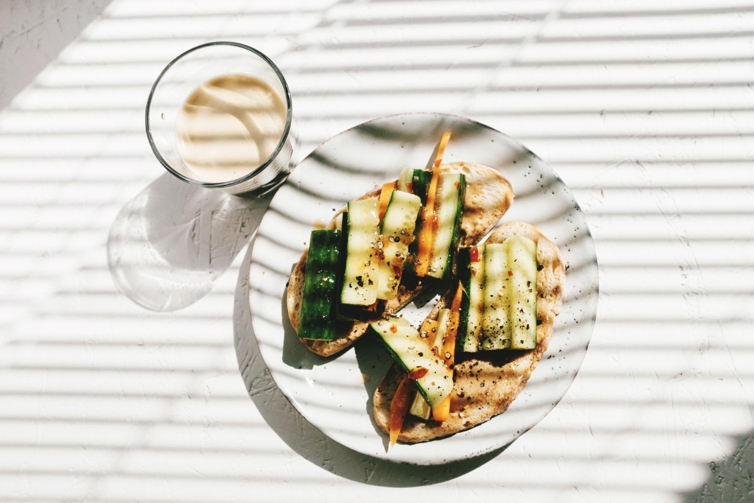 Plant based breakfast of bread with cucumber, carrot and pepper